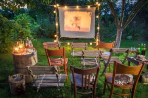 Summer cinema with retro projector in the garden